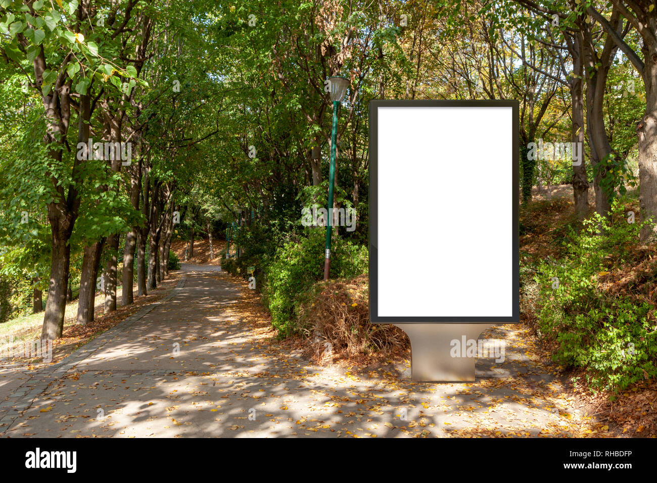 Blank street billboard poster stand in the park Stock Photo - Alamy