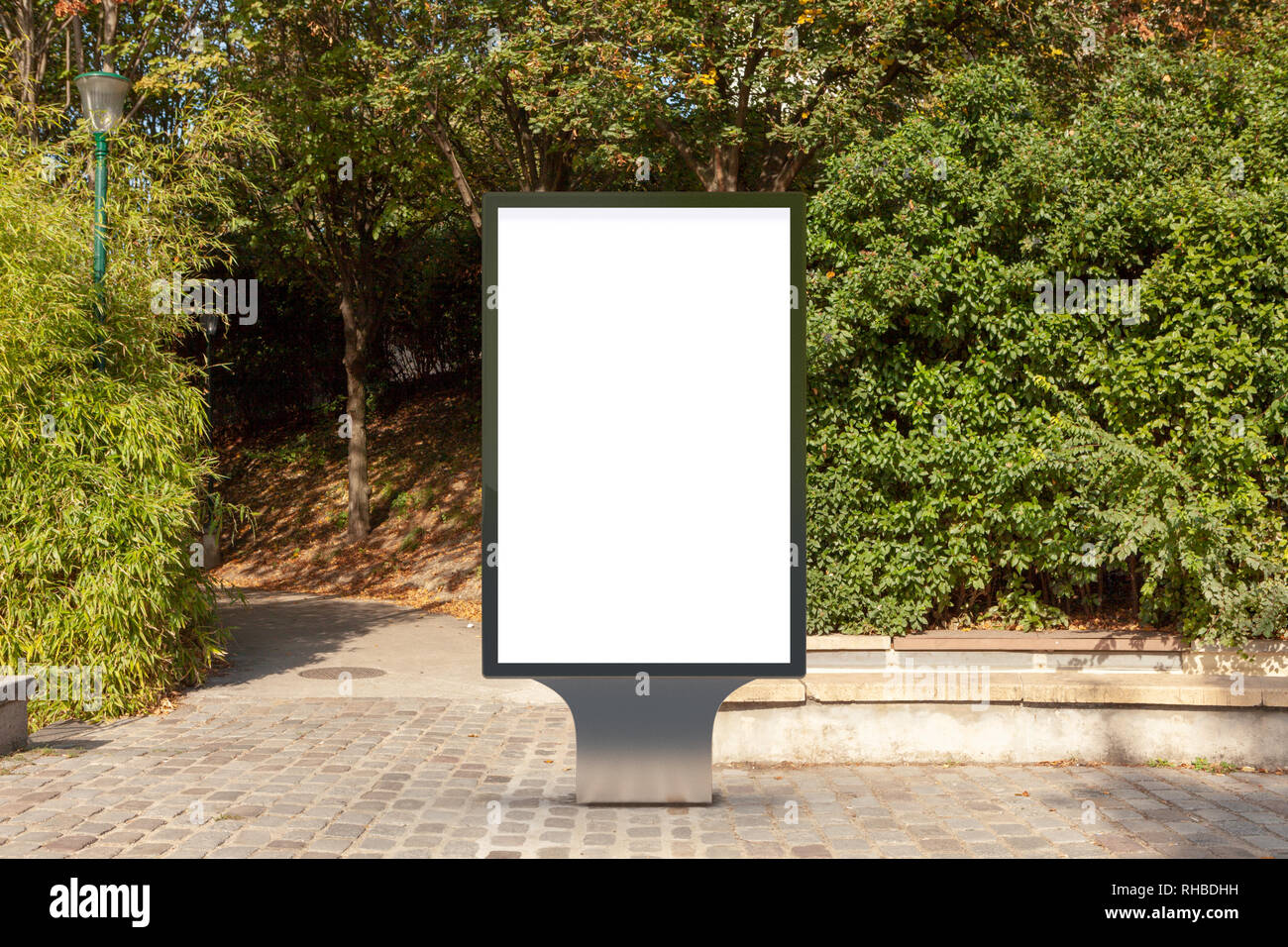 Blank street billboard poster stand in the park Stock Photo - Alamy
