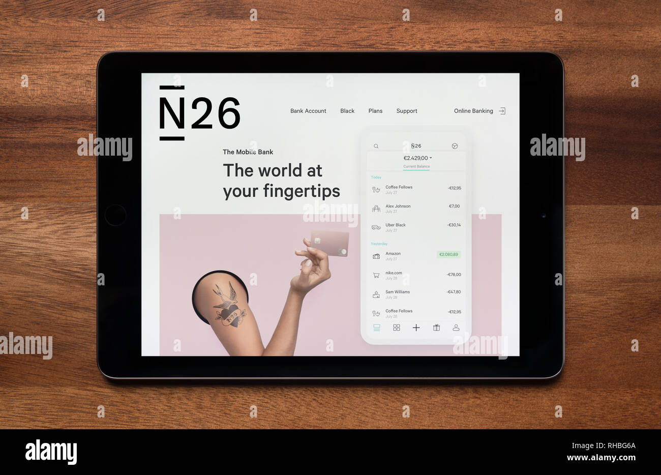 The website of N26 Bank is seen on an iPad tablet, which is resting on a wooden table (Editorial use only). Stock Photo