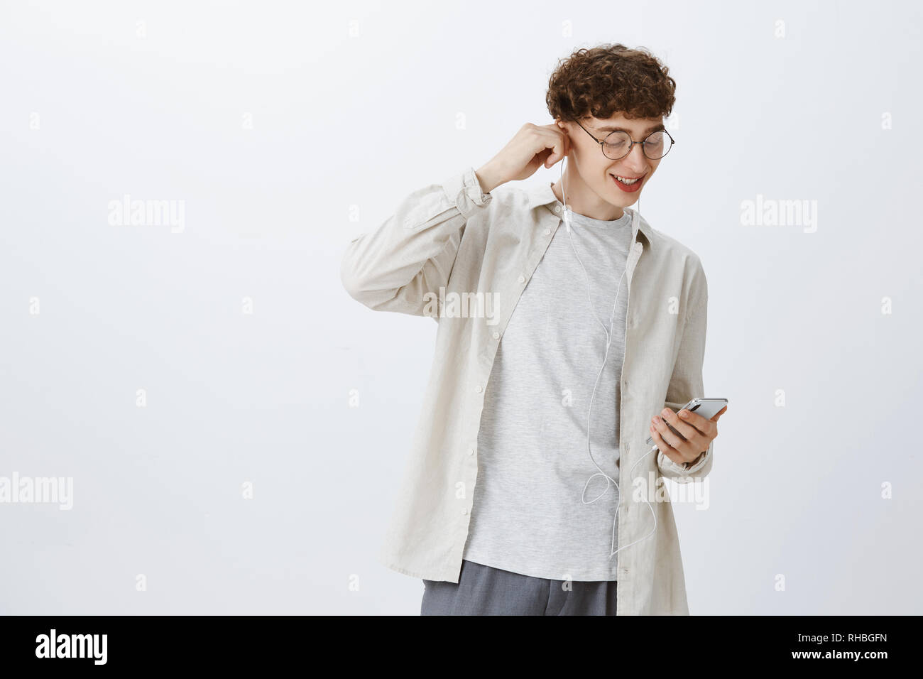 Portrait Of Stylish Modern Hipset Guy With Curly Hair In