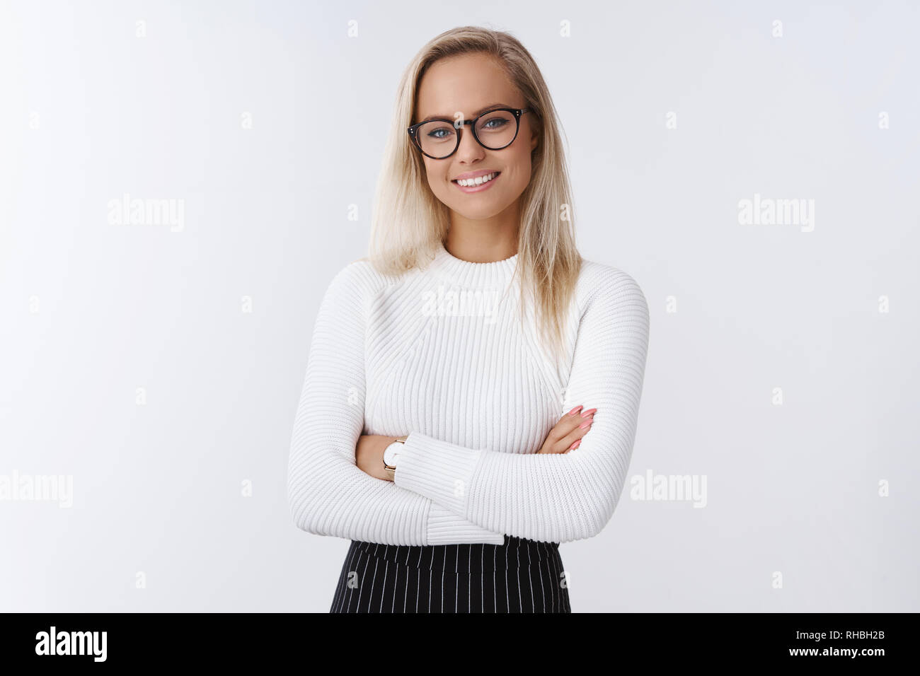 Attractive female company hr smiling broadly standing in confident pose ...