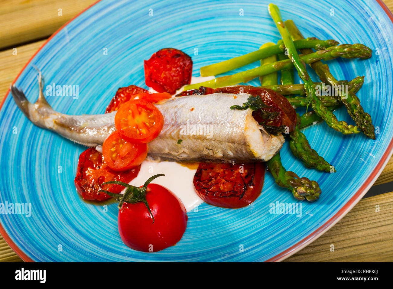Delicious baked whiting with fresh and sundried tomatoes, asparagus