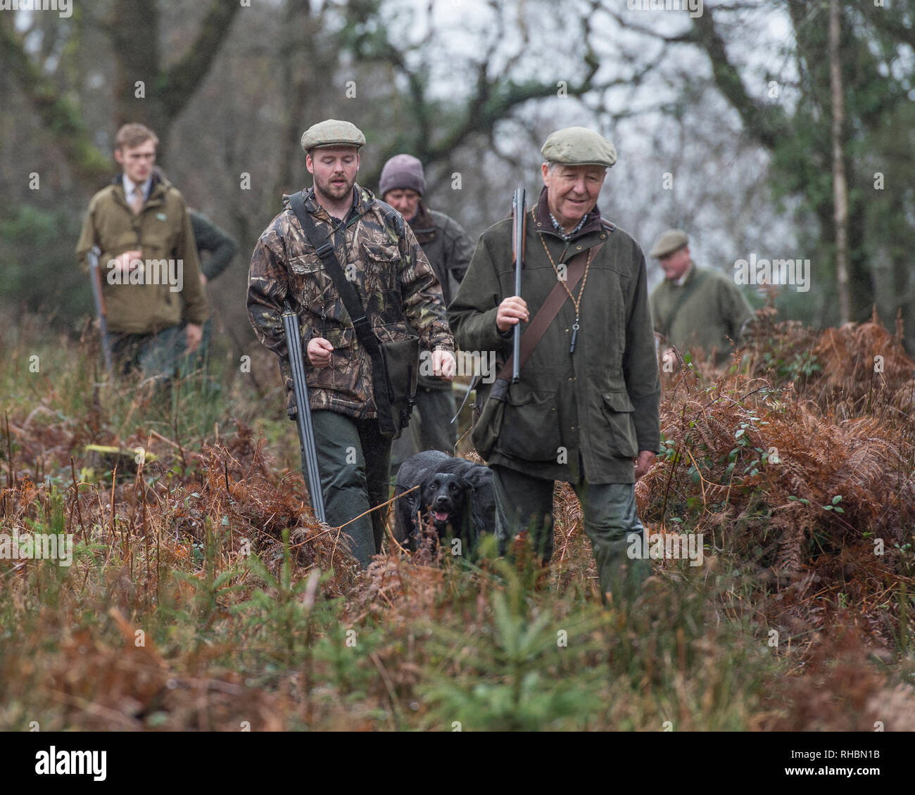 group of hunters with guns walking Stock Photo