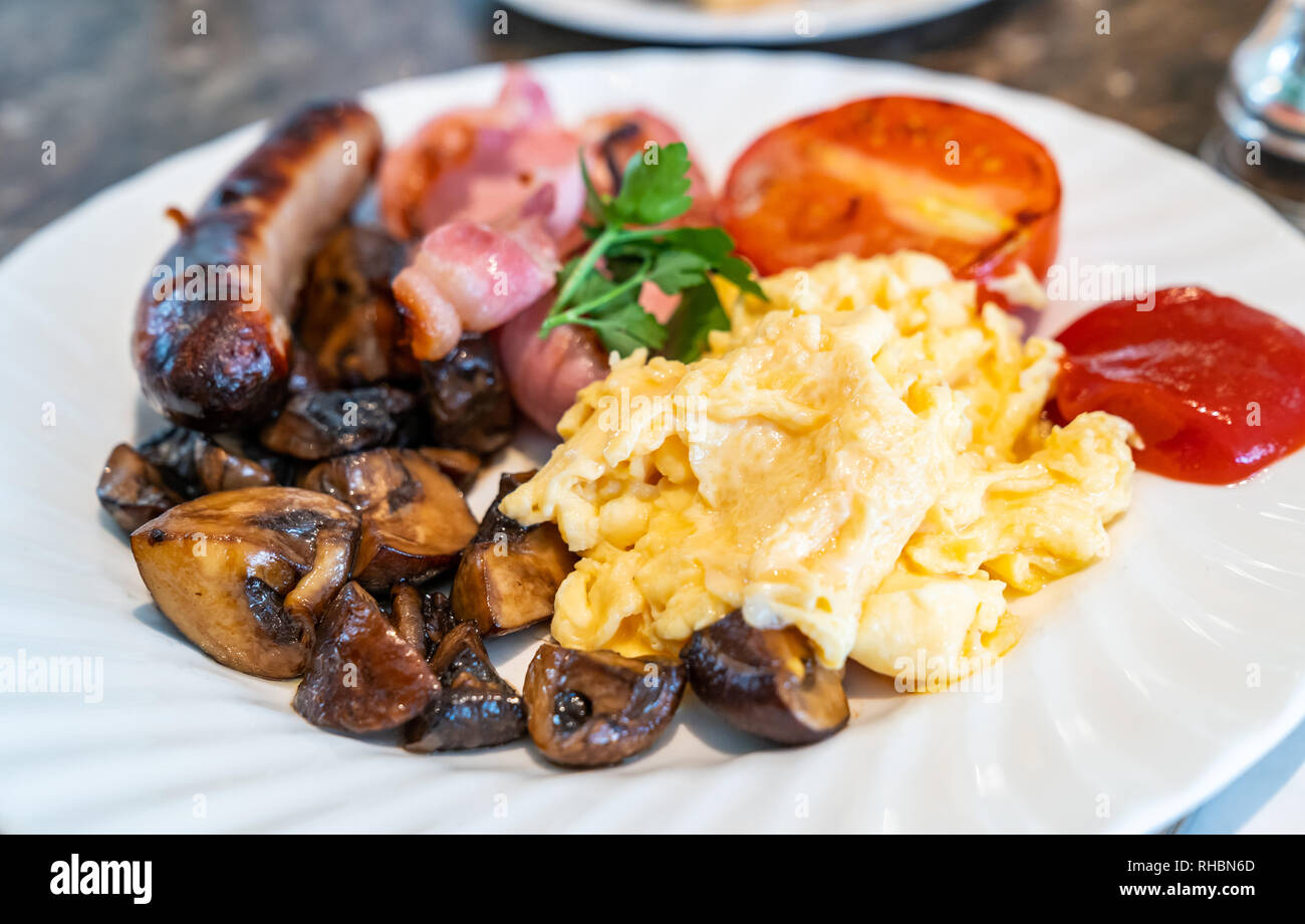 Full English Breakfast on Table with coffee Stock Photo
