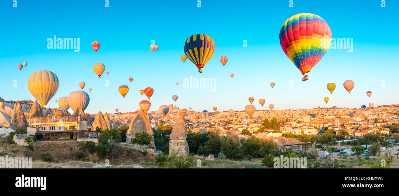 Colorful hot air balloons flying over at fairy chimneys in Nevsehir, Goreme, Cappadocia Turkey. Hot air balloon flight at spectacular Cappadocia Turke Stock Photo