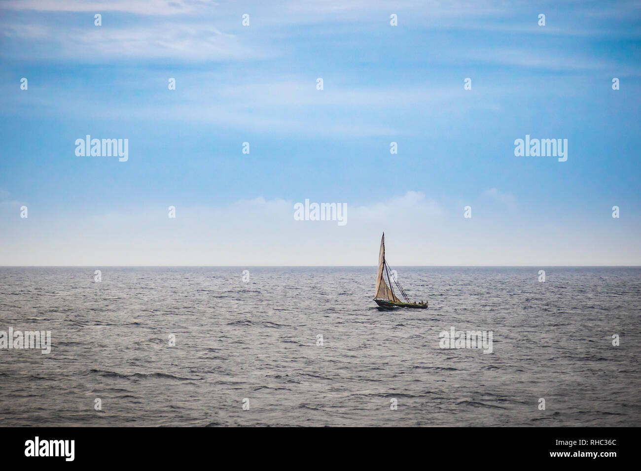 Dhow wooden boat sailing on the Indian Ocean near Zanzibar, Tanzania Stock Photo