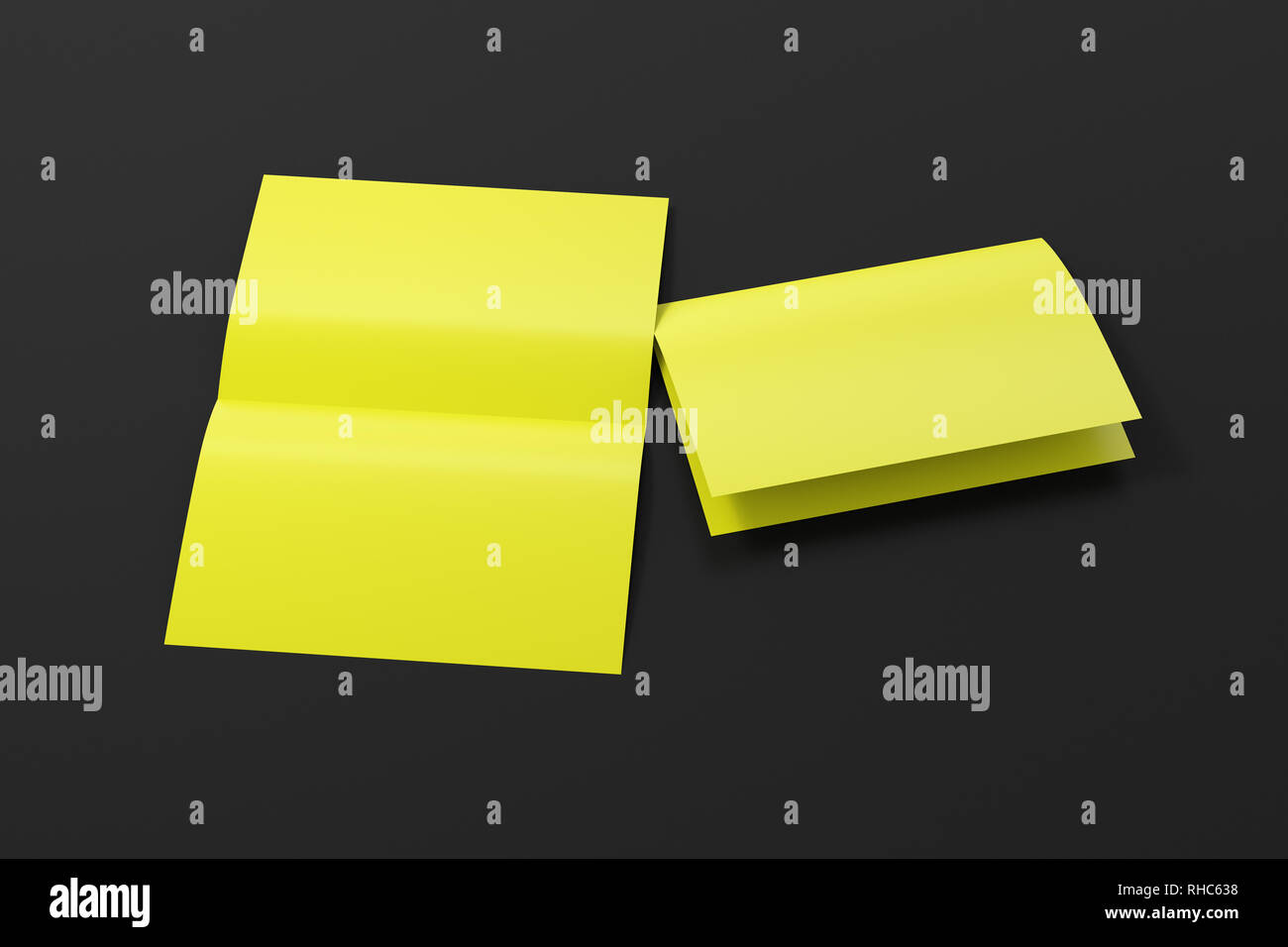 Blank yellow open and folded half-folded flyer leaflet on black background. With clipping path around brochure Stock Photo