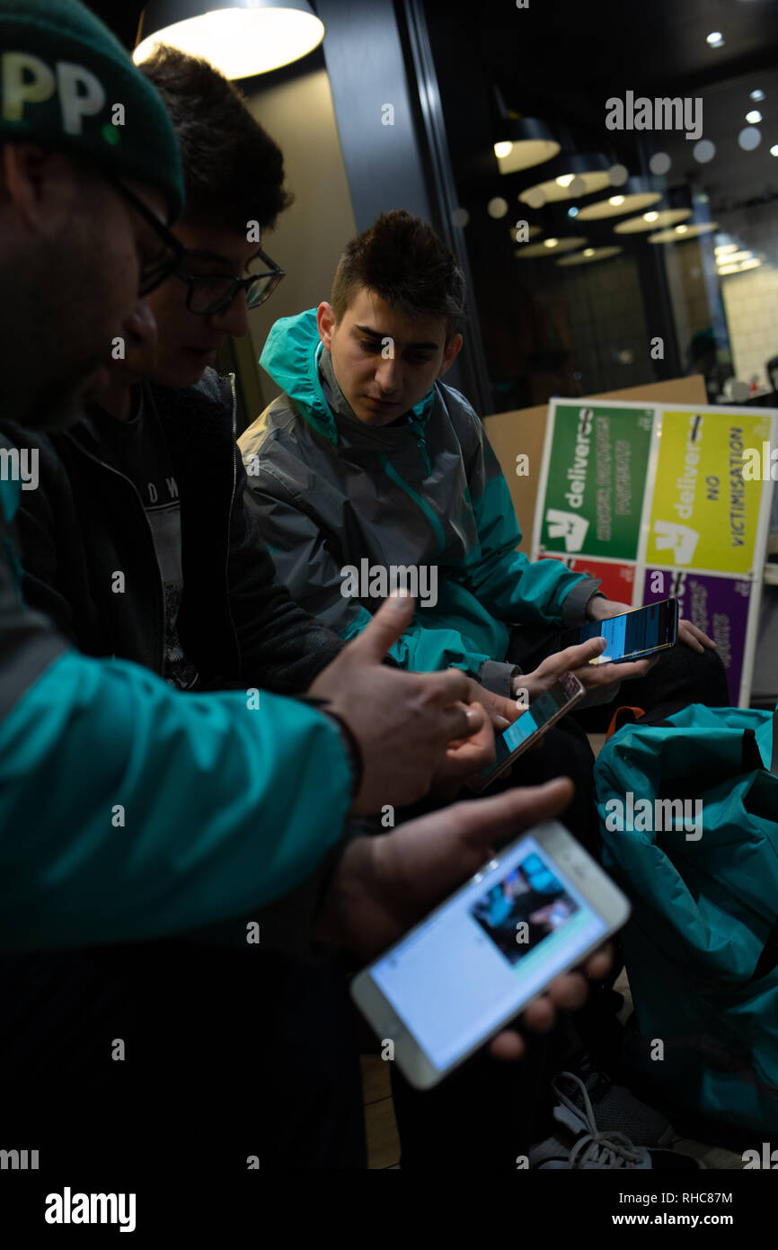 Cheltenham, UK. 01st Feb, 2019. Deliveroo employees warm up in McDonald's before the strike Credit: Victor Storublev/Alamy Live News Stock Photo