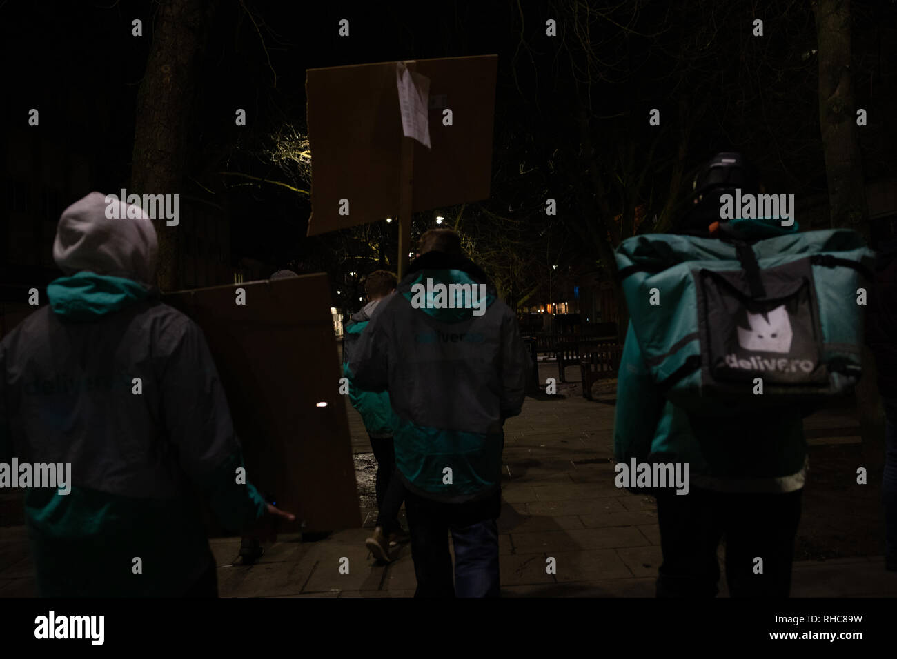 Cheltenham, UK. 01st Feb, 2019. Backs of three deliveroo protesters. Credit: Victor Storublev/Alamy Live News Stock Photo