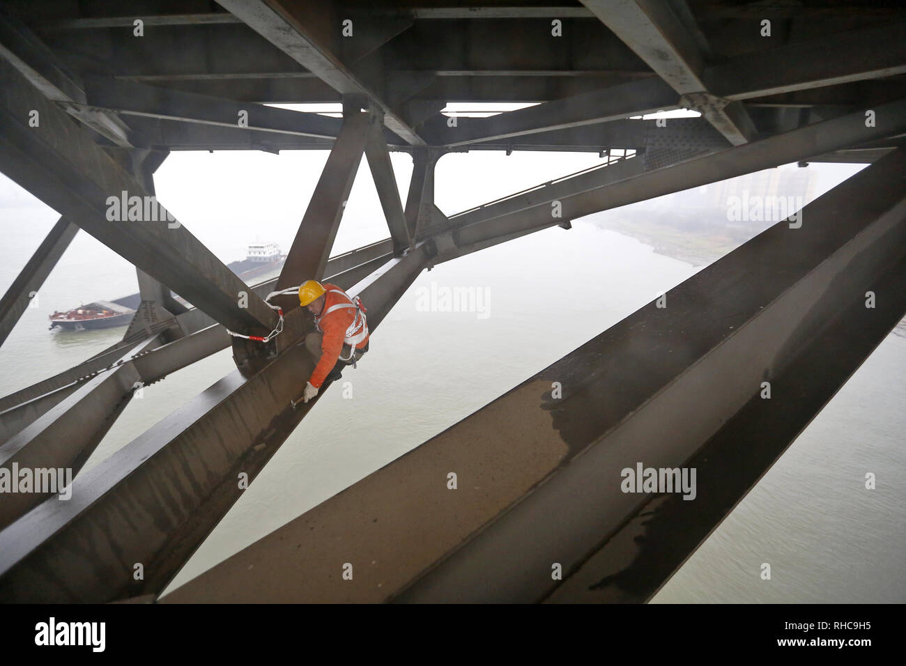 Beijing, China's Jiangxi Province. 31st Jan, 2019. A bridge worker checks the Jiujiang Yangtze River Bridge, a double-decked road-rail truss bridge and an important section of Beijing-Kowloon (Jingjiu) Railway in Jiujiang, east China's Jiangxi Province, Jan. 31, 2019. Safety inspections have been strengthened to secure transportation during the 2019 Spring Festival travel rush. Credit: Ding Bo/Xinhua/Alamy Live News Stock Photo