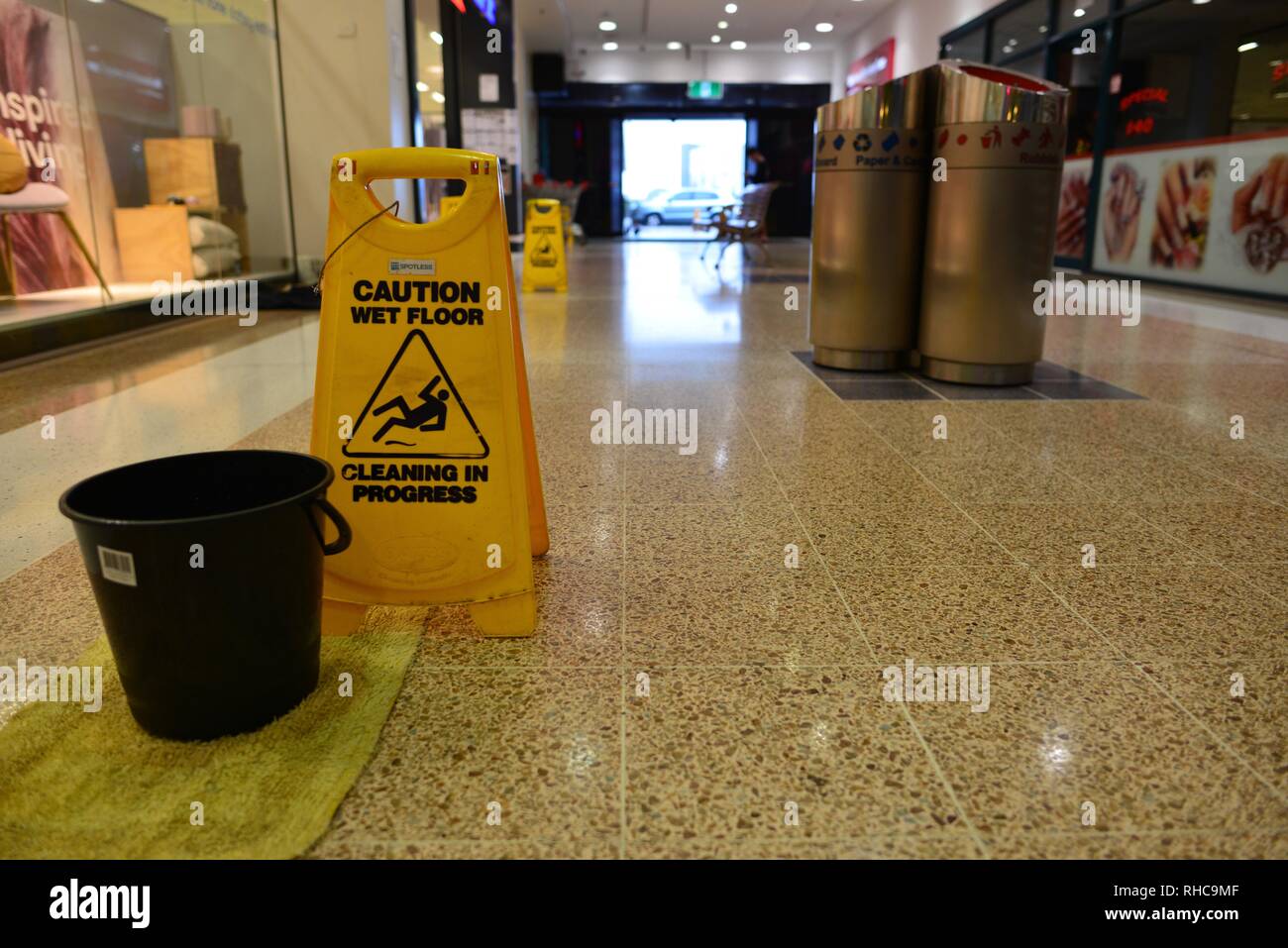 Caution Wet Floor Sign And A Bucket Inside Stockland Shopping