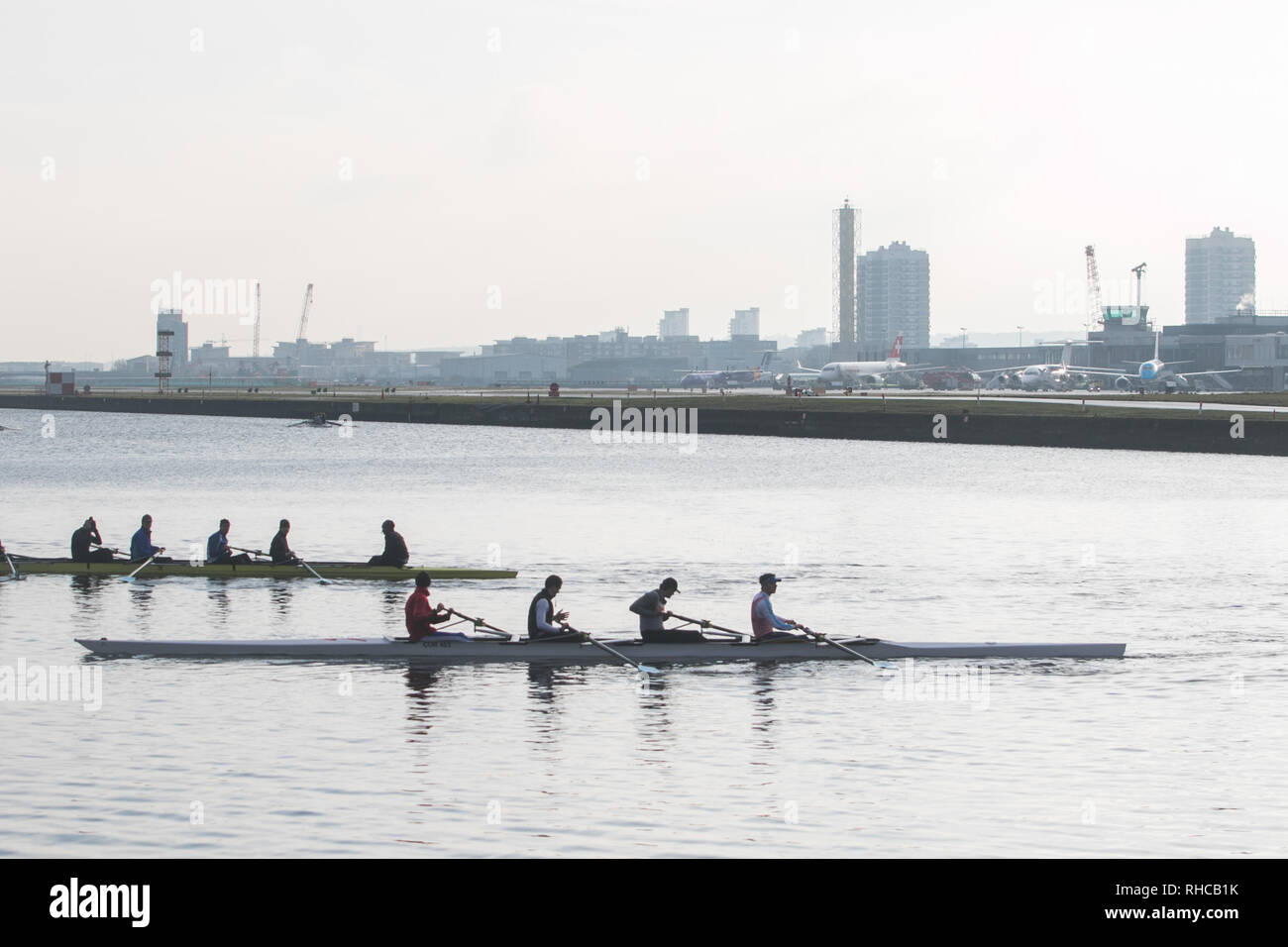 London, UK. 2nd Feb, 2019. Rowers on Royal Docks next to the runway as  London City airport in Docklands reopens after heavy snow forced the airport to be closed with planes grounded and flight cancellations Credit: amer ghazzal/Alamy Live News Stock Photo