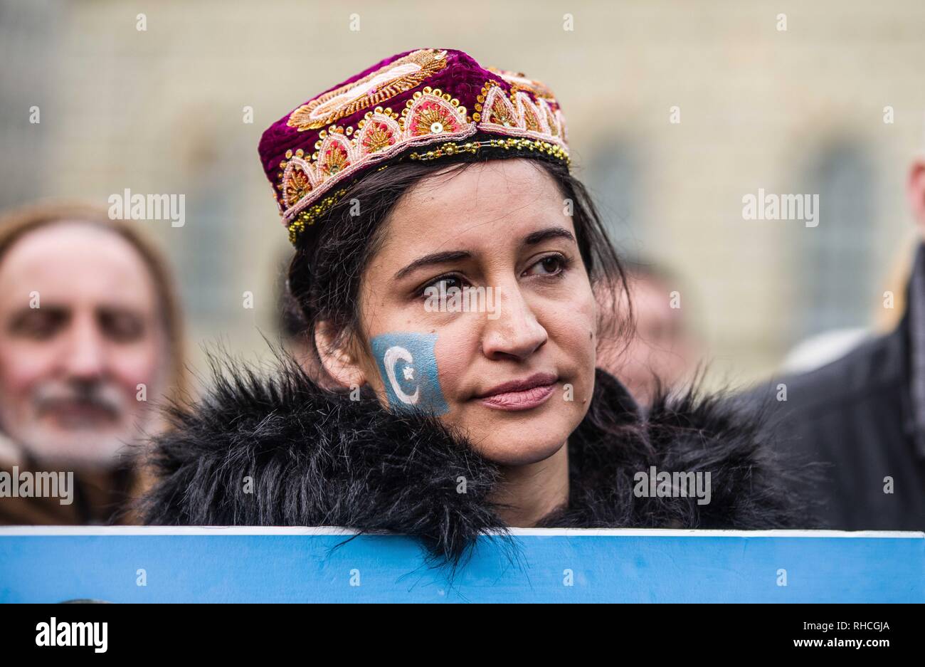 Munich, Bavaria, Germany. 2nd Feb, 2019. A uyghur has the flag of East Turkestan painted on her face. to protest against the so-called 'Muslim Crackdown'' by the Chinese Communist Party in the Xinjiang Autonomous Region of China. The region is contains roughly 26 million people, 11 million of whom are the ethnically Turkic Uyghurs who still call the region East Turkistan . The CCP has placed upwards of 1 million Uyghurs in reeducation camps, as well as performing widespread surveillance of the non-Han r Credit: ZU Credit: ZUMA Press, Inc./Alamy Live News Stock Photo