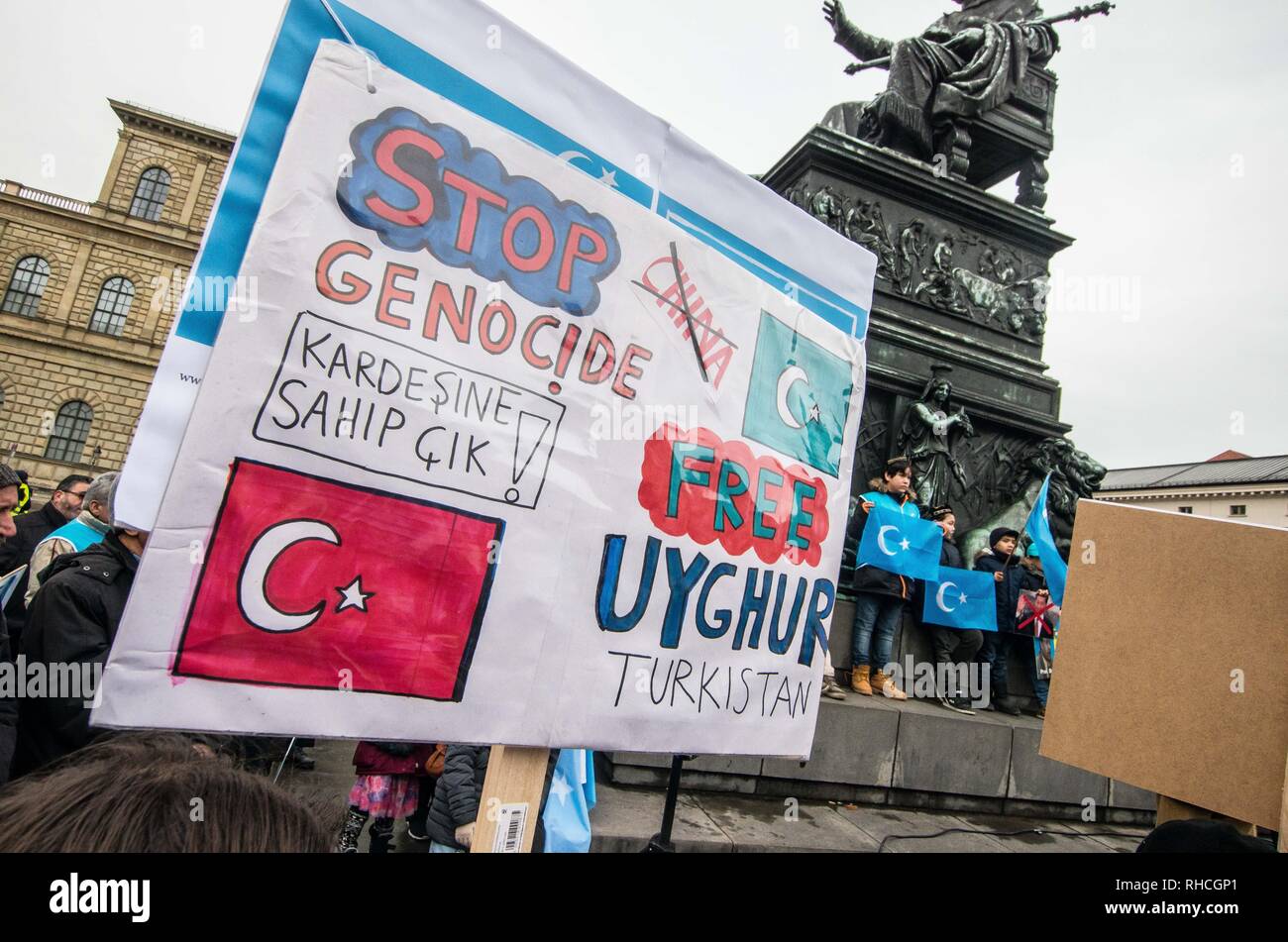 Munich, Bavaria, Germany. 2nd Feb, 2019. A sign calling for an end to alleged genocide taking place in East Turkistan, also known as the Xinjiang Province of China. In the background are Uyghur children holding the flags of East Turkestan. to protest against the so-called 'Muslim Crackdown'' by the Chinese Communist Party in the Xinjiang Autonomous Region of China. The region is contains roughly 26 million people, 11 million of whom are the ethnically Turkic Uyghurs who still call the region East Turkis Credit: ZU Credit: ZUMA Press, Inc./Alamy Live News Stock Photo