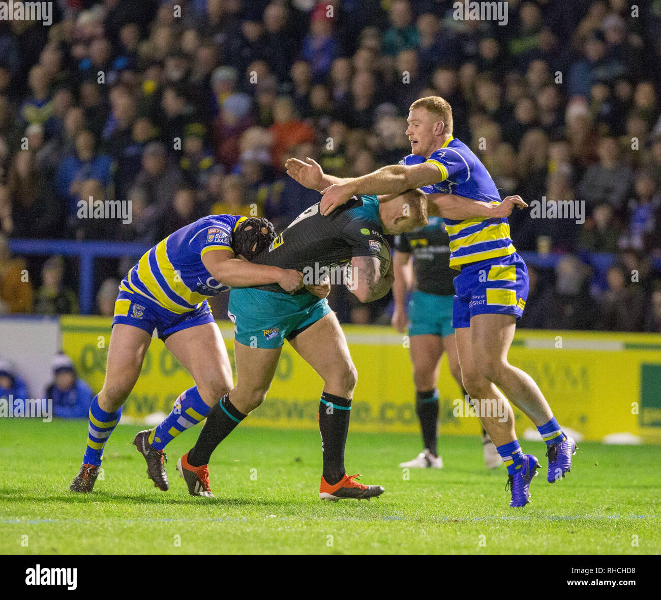 Halliwell Jones Stadium, Warrington, UK. 2nd Feb, 2019. Betfred Super League rugby, Warrington Wolves versus Leeds Rhinos; Liam Sutcliffe is tackled by Jack Hughes Credit: Action Plus Sports/Alamy Live News Stock Photo