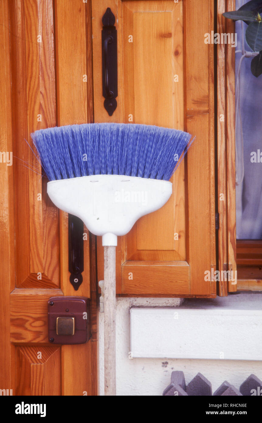 Burano island, Venice, Italy - broom propped against a wooden door Stock Photo
