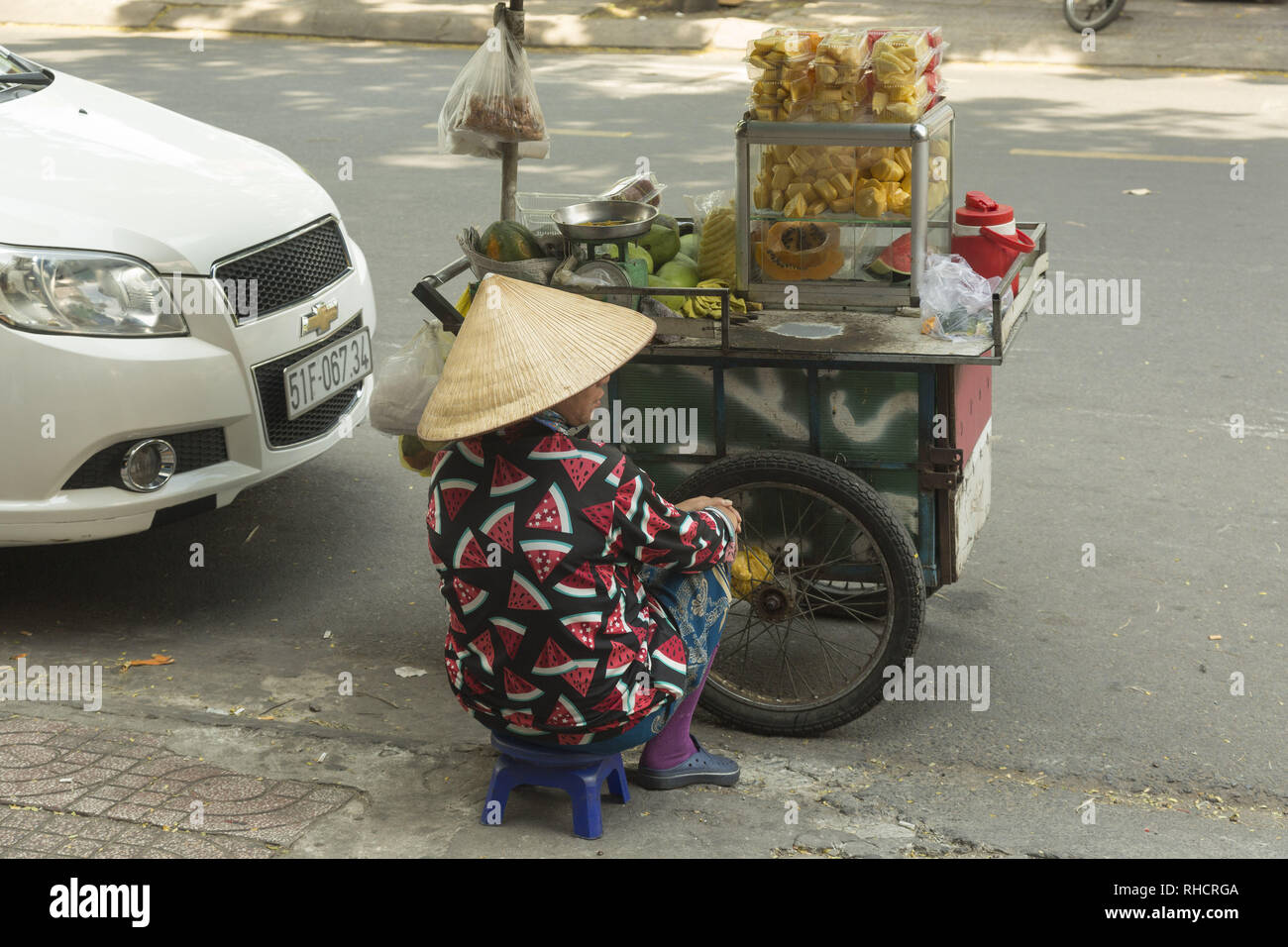 Woman selling fruits on the street in Vietnam Stock Photo