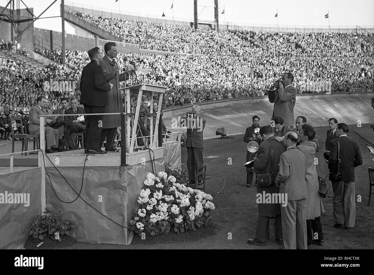 Billy Graham preaching at Olympic Stadium in Amsterdam, North Holland on June 22, 1954. Stock Photo