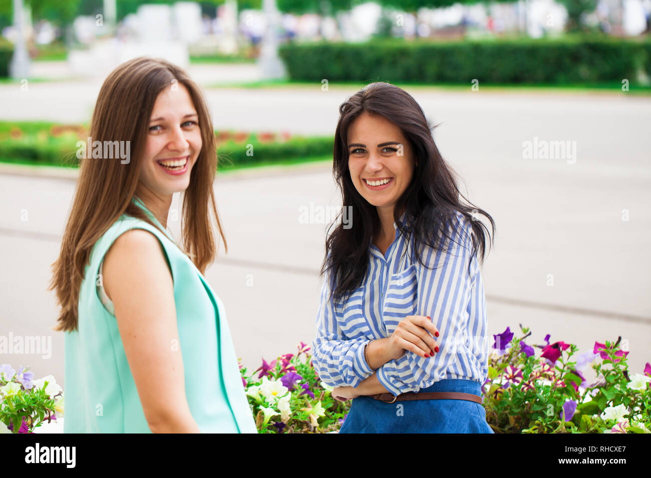 Two young women talking to each other. Girl friends having a chat. Stock Photo