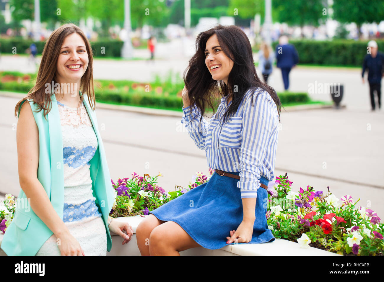 Two young women talking to each other. Girl friends having a chat. Stock Photo