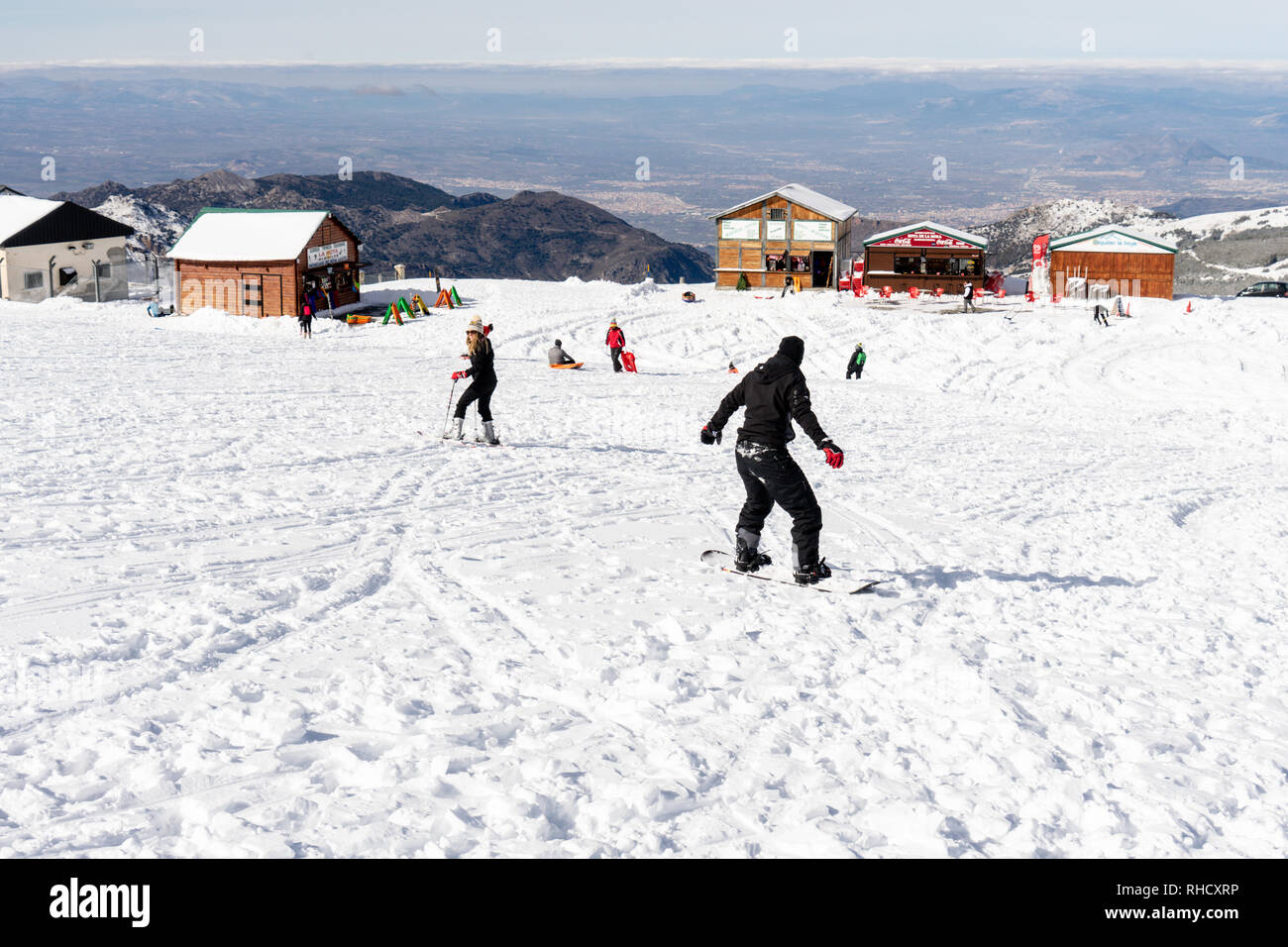People having fun doing winter sports in Sierra Nevada Stock Photo Alamy