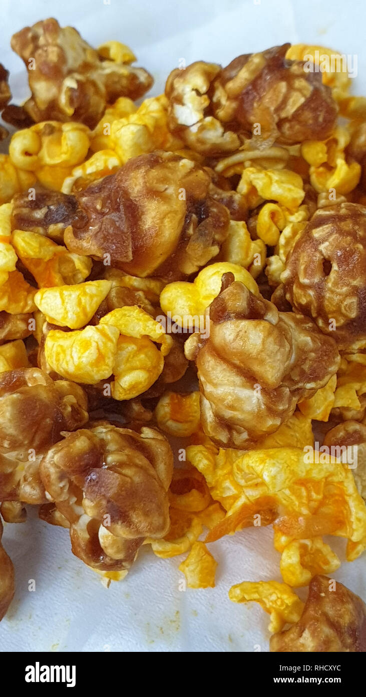 Caramel-flavored popcorn snacks on a tissue at the table Stock Photo