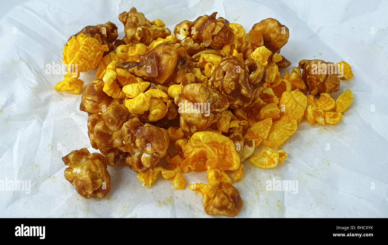 Caramel-flavored popcorn snacks on a tissue at the table Stock Photo