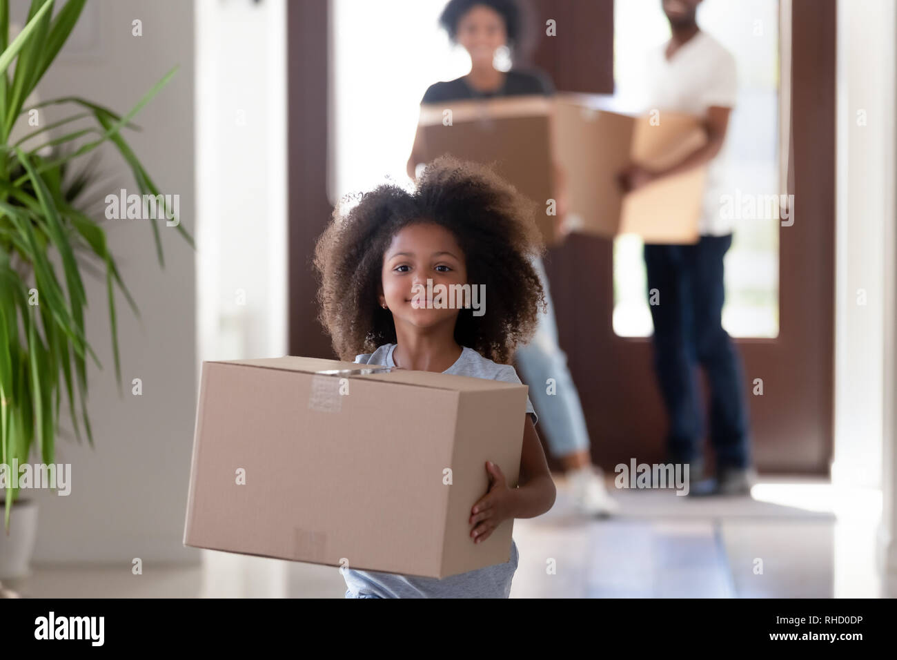 Cute funny african kid girl holding box in new house Stock Photo Alamy