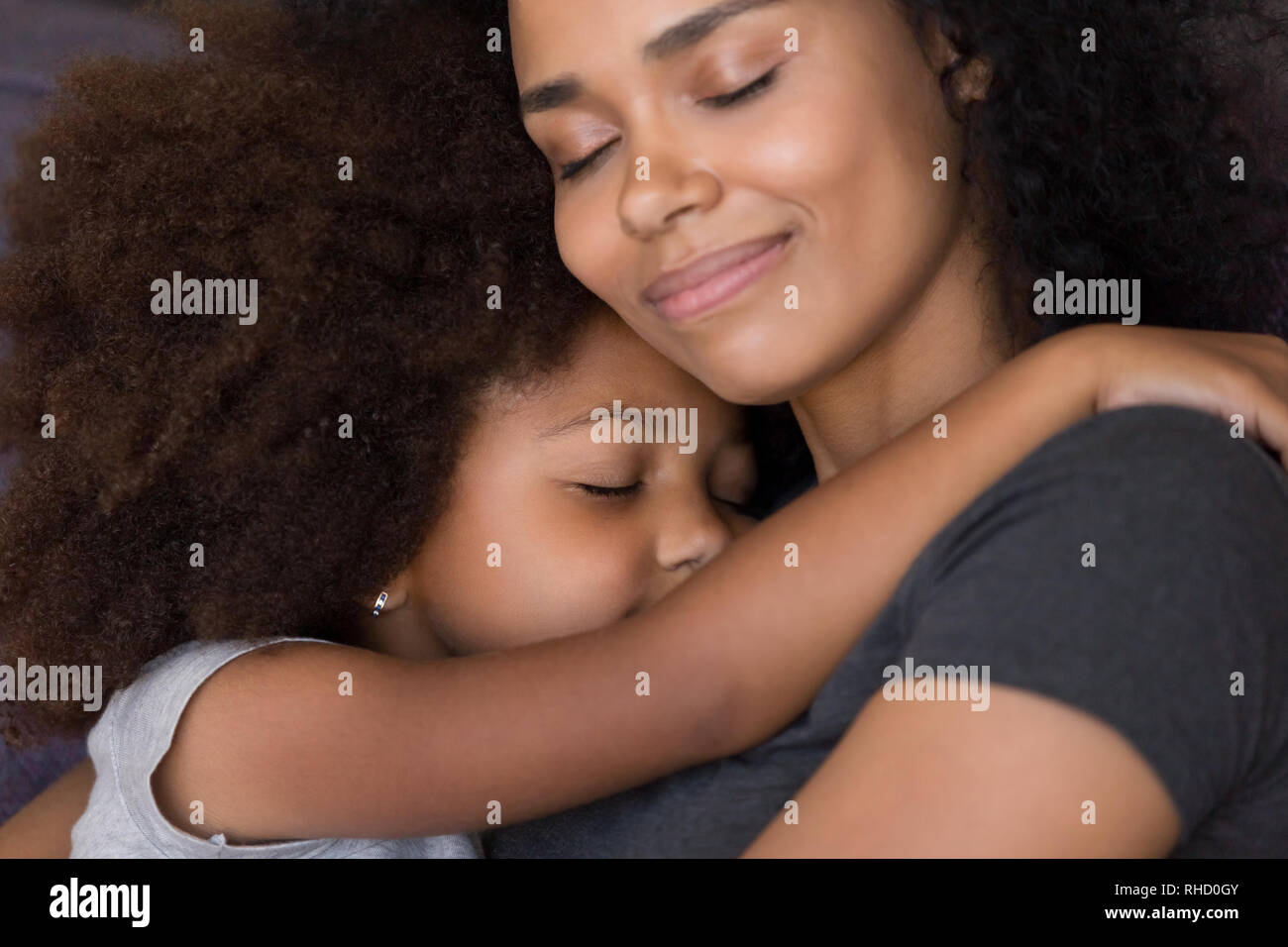 Loving single black mother hugs cute daughter feel tenderness connection Stock Photo