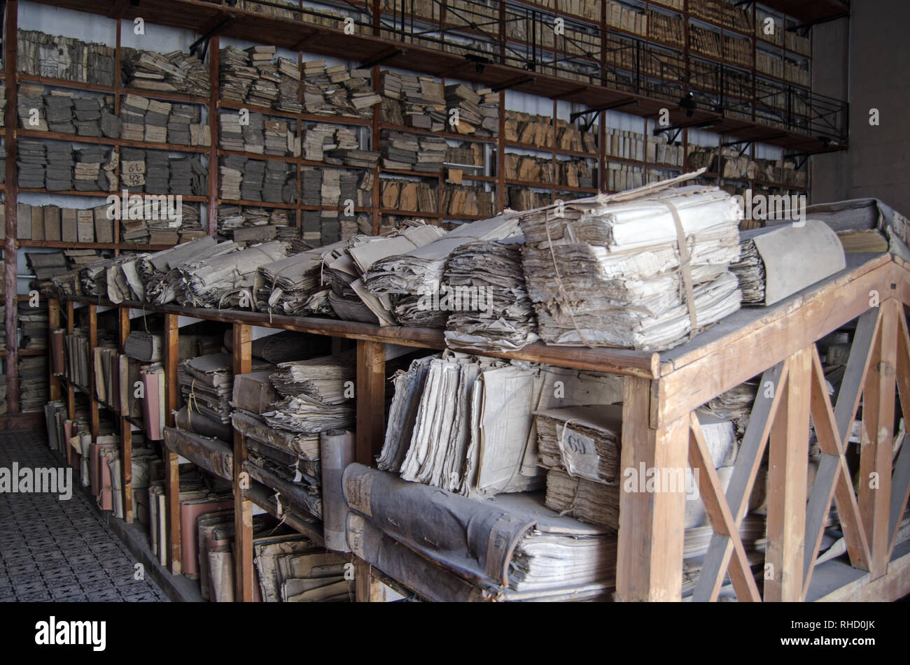 PALERMO, ITALY - JUNE 16, 2018:  Bundles of old papers and files stacked on shelves belonging to the State Archives of Palermo, Sicily.  Papers dating Stock Photo