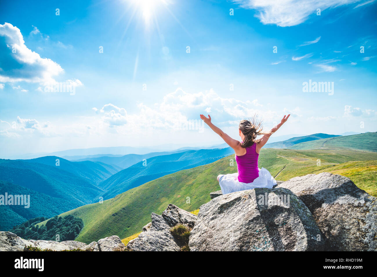 Young woman meditate on the top of mountain Stock Photo - Alamy