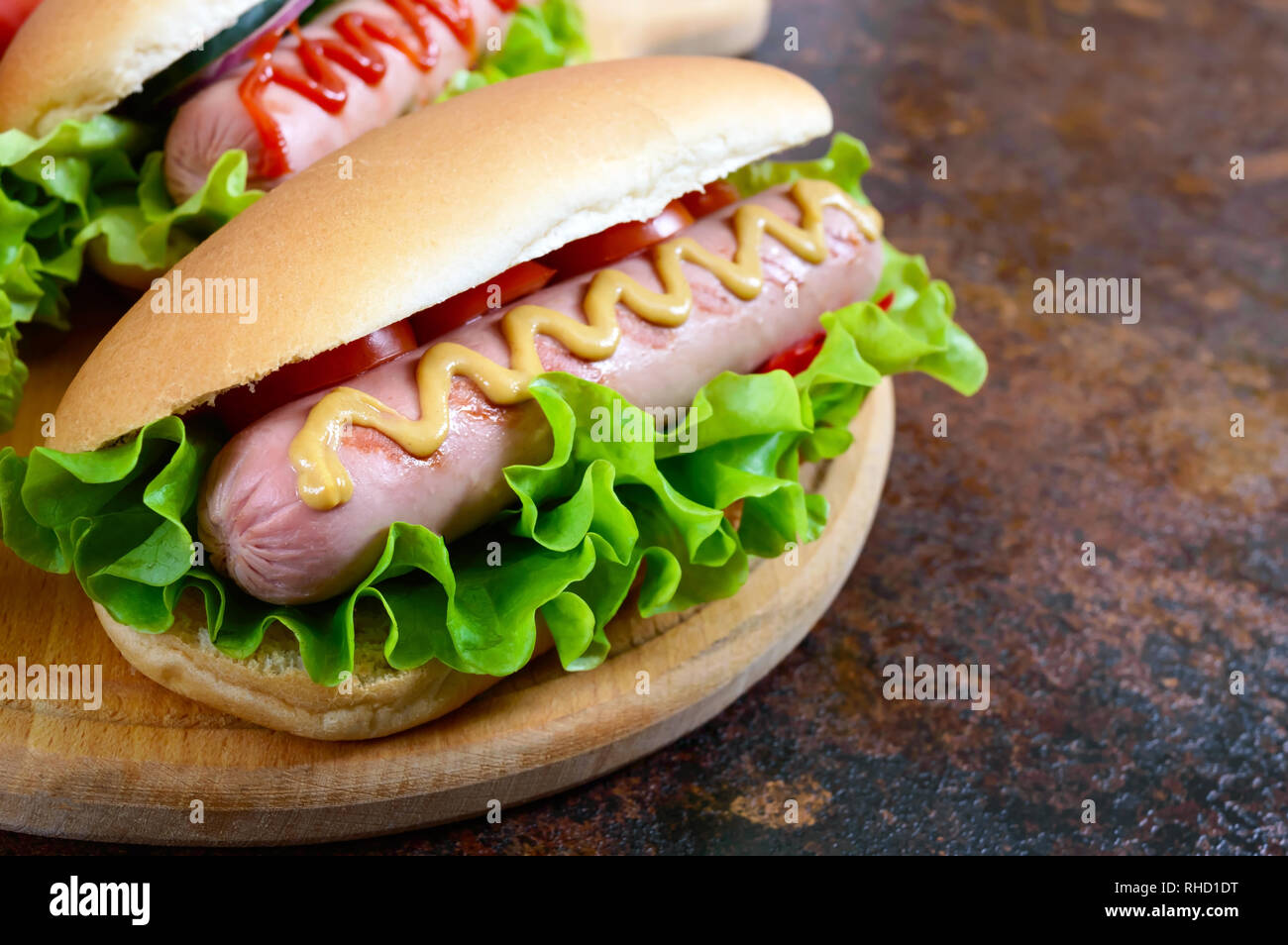 Delicious hot dogs with sausage grill, ketchup, mustard, lettuce