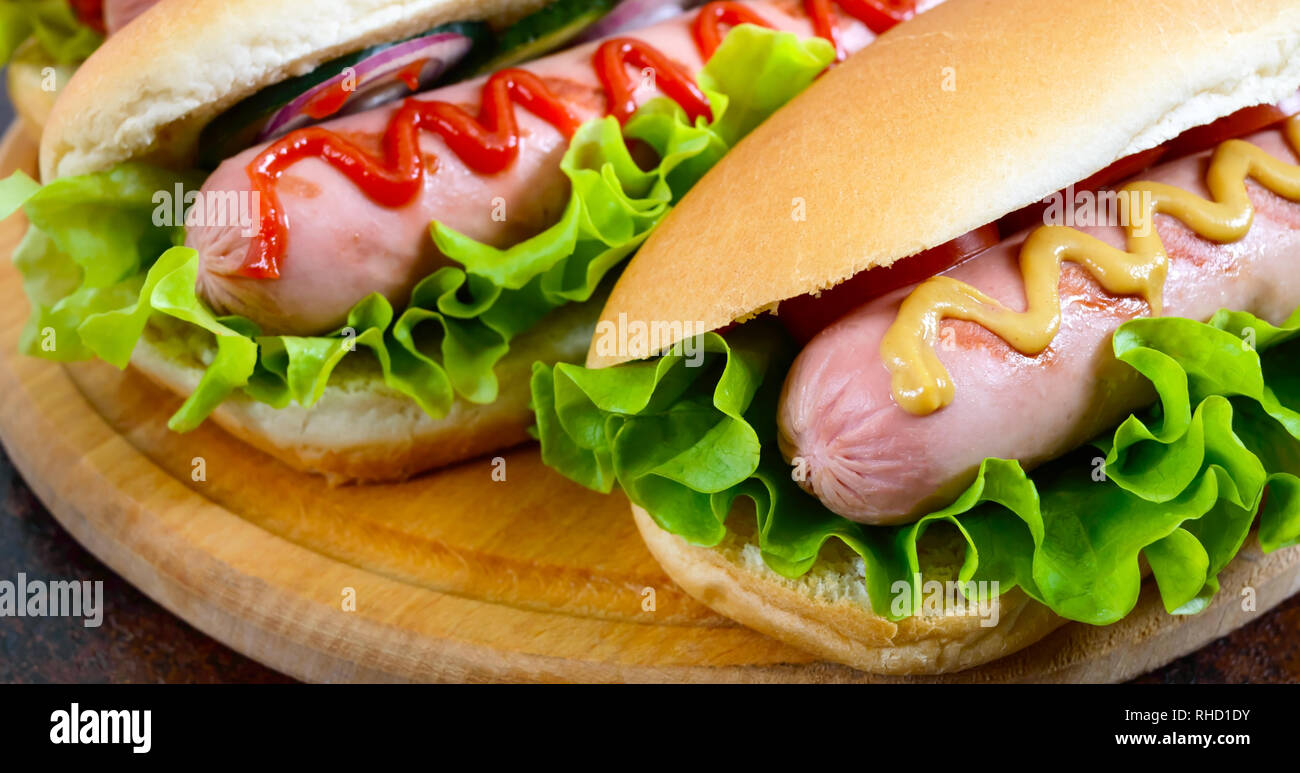 Delicious hot dogs with sausage grill, ketchup, mustard, lettuce