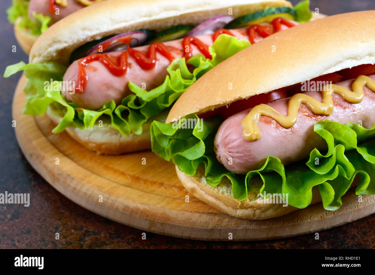 Delicious hot dogs with sausage grill, ketchup, mustard, lettuce