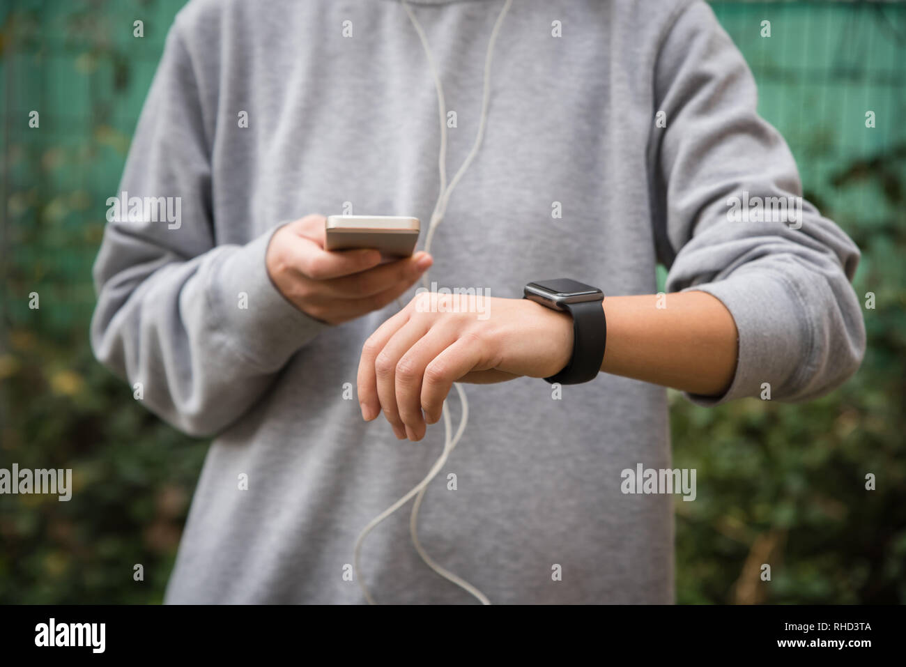 Young woman using wearable tech during fitness workout Stock Photo