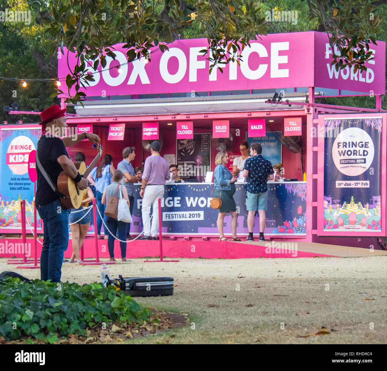 Busker playing a guitar if front of Pop up box office at Fringe World Festival Russell Square Northbridge Perth WA Australia. Stock Photo