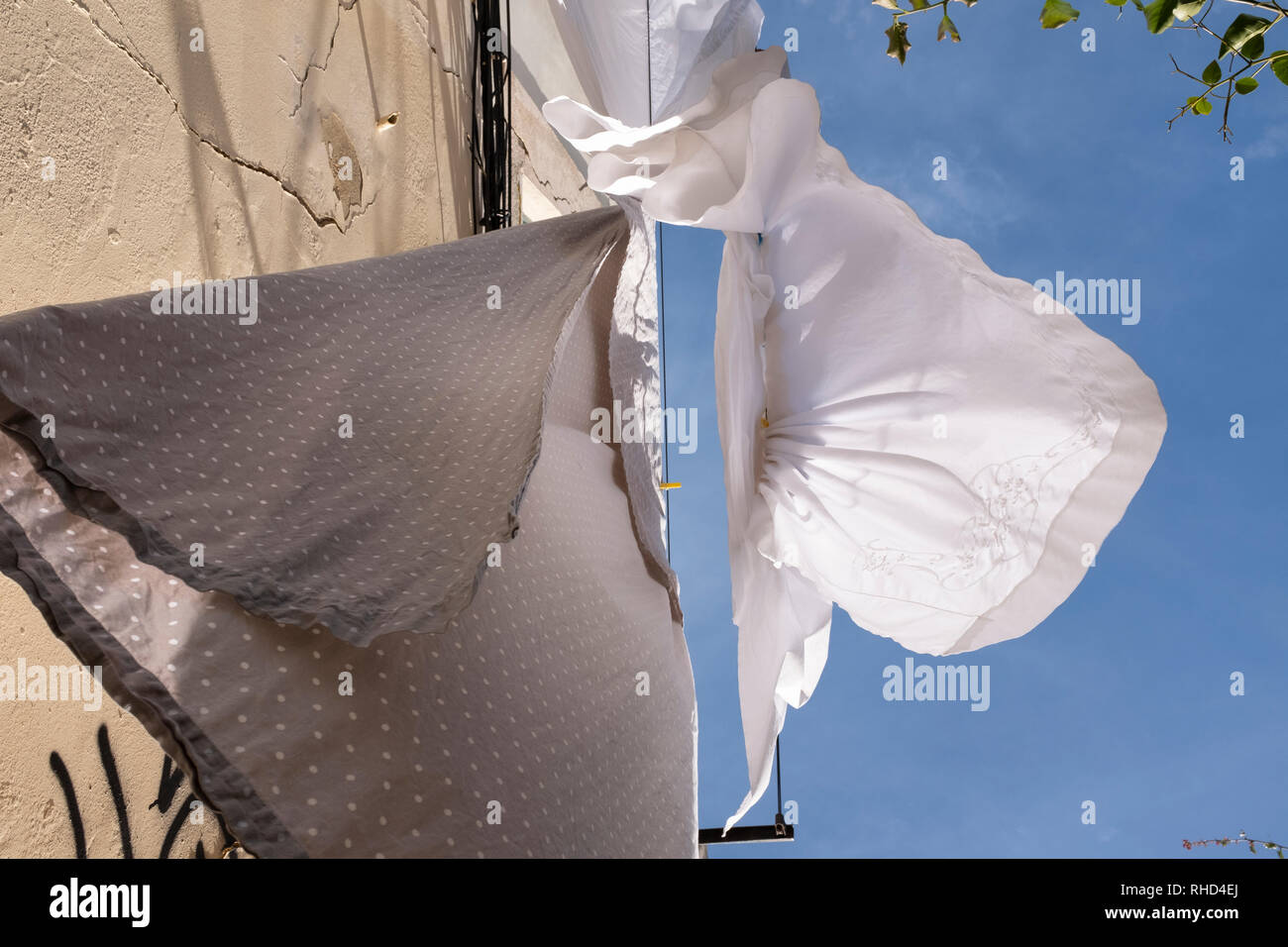 Pure white sheets hanging out to dry on a windy day on a washing line
