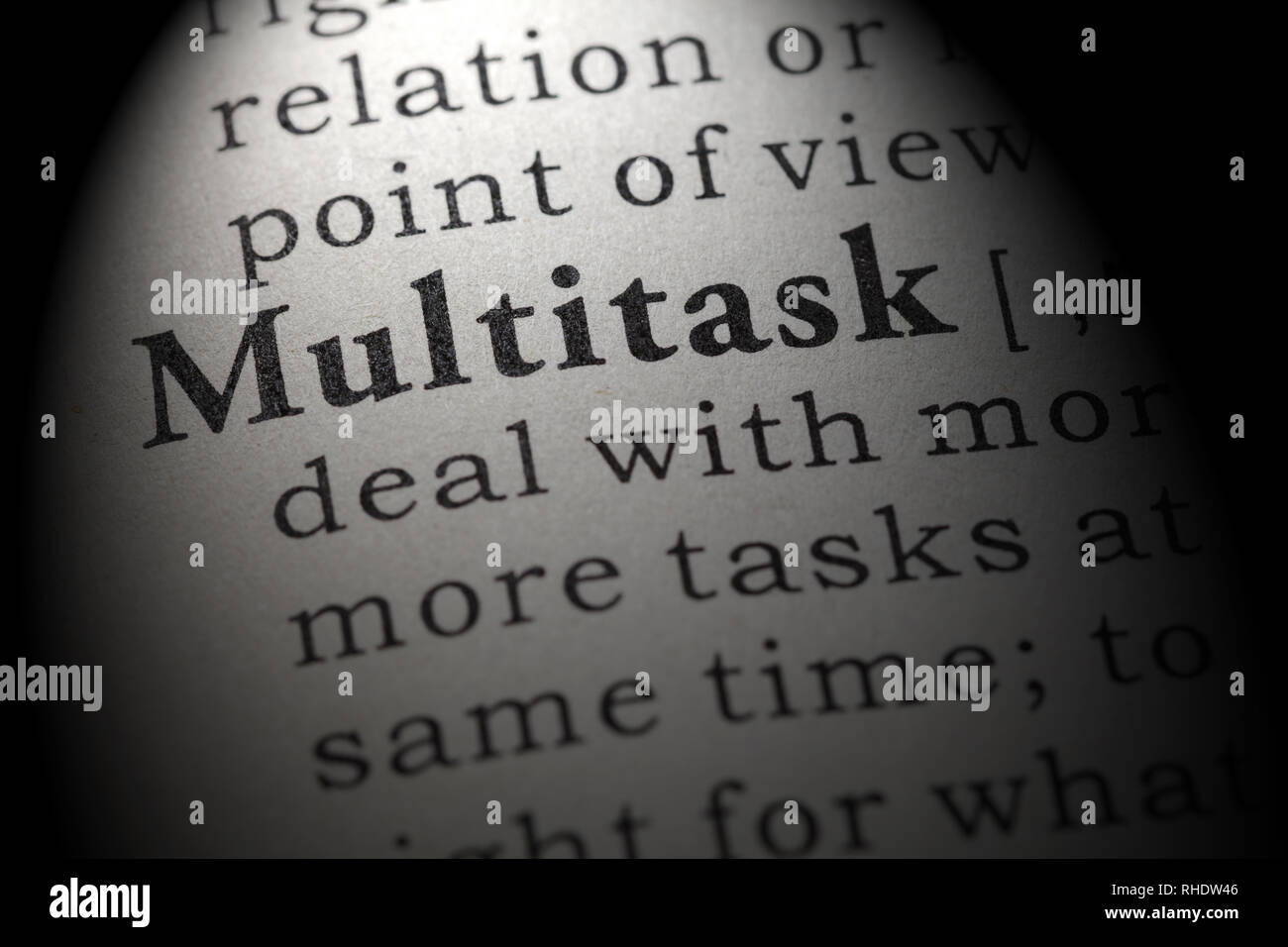 Fake Dictionary, Dictionary definition of the word multitask. including key descriptive words. Stock Photo