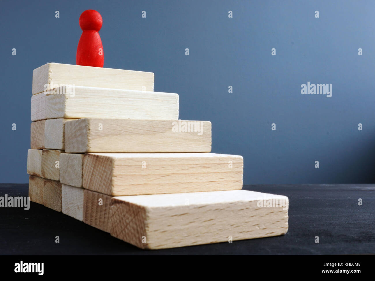 Ladder of success from wooden blocks. Ambitions and achievements concept. Stock Photo