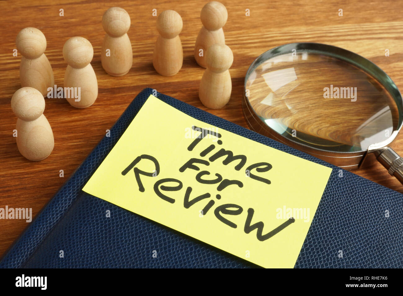 Time for review. Magnifying glass and notepad. Stock Photo