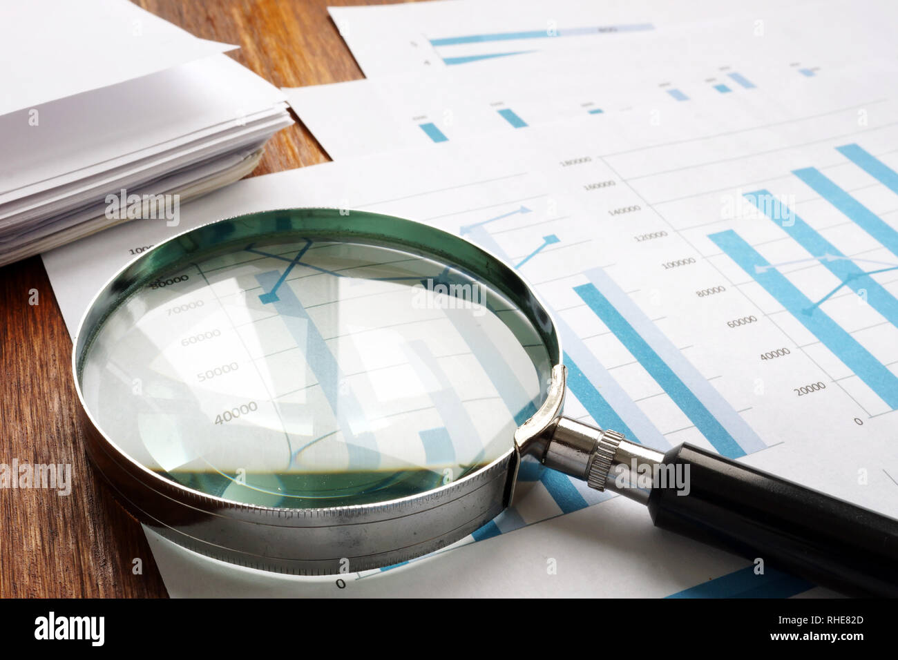 Audit and accounting concept. Magnifier and business papers. Stock Photo