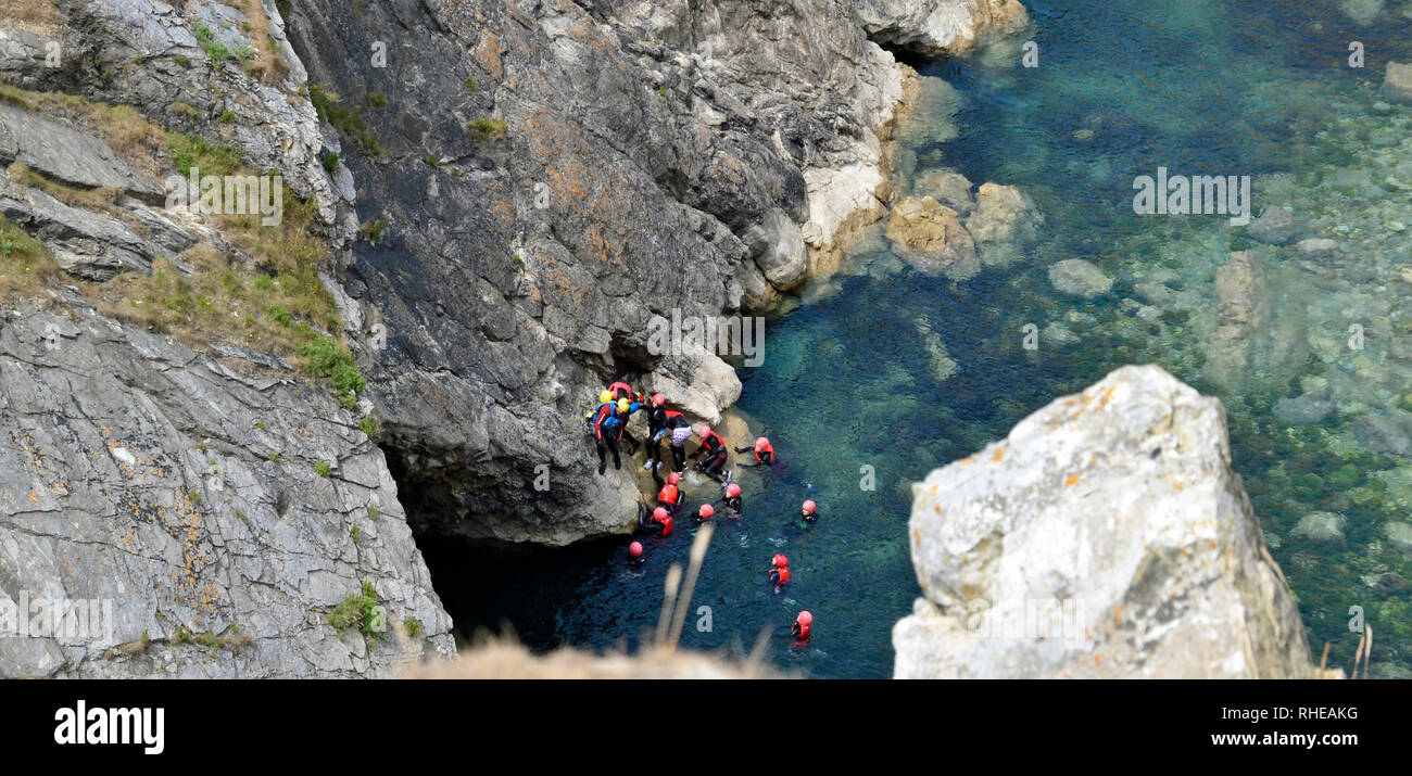 Rock climbing, tombstoning, and orienteering at Lulworth Cove, Dorset, UK. Part of the Jurassic coast. Stock Photo