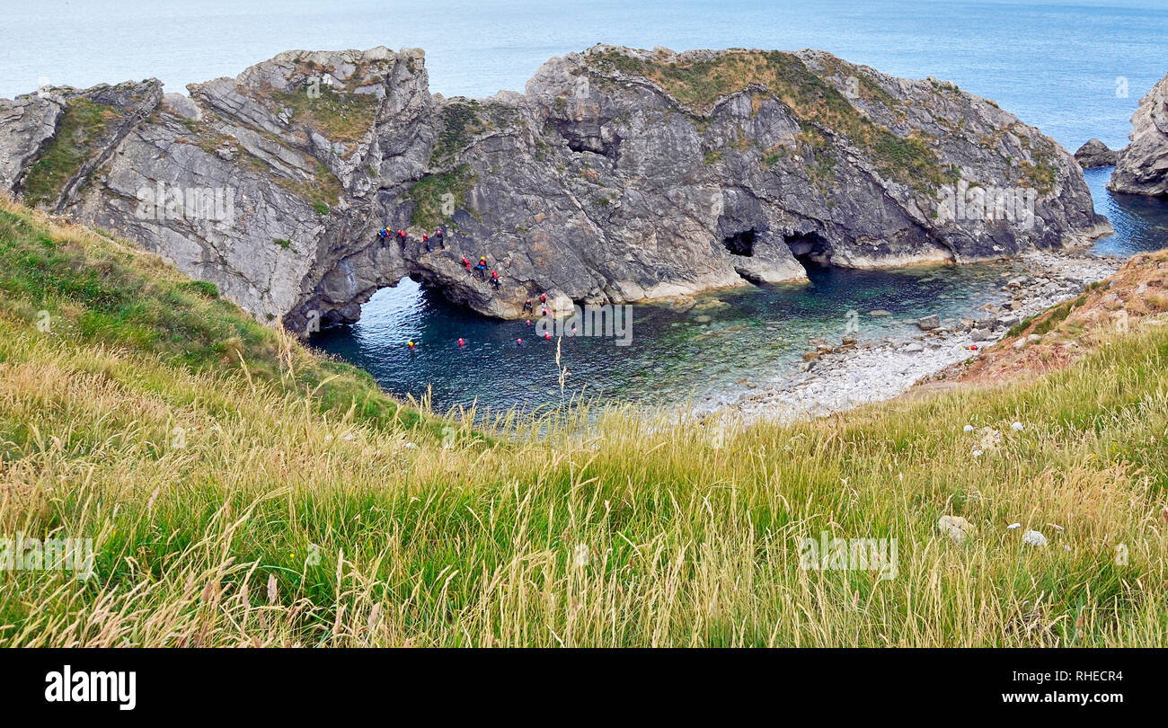 Rock climbing, tombstoning, and orienteering at Lulworth Cove, Dorset, UK. Part of the Jurassic coast. Stock Photo