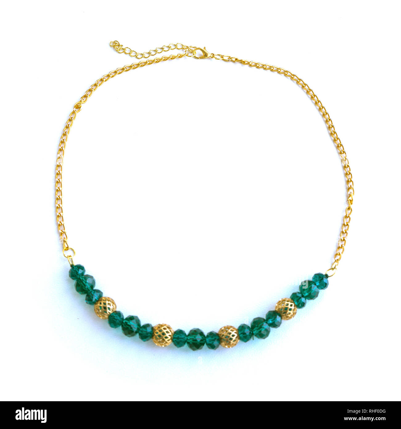 Handmade necklace from green beads and gold chain. Stock Photo