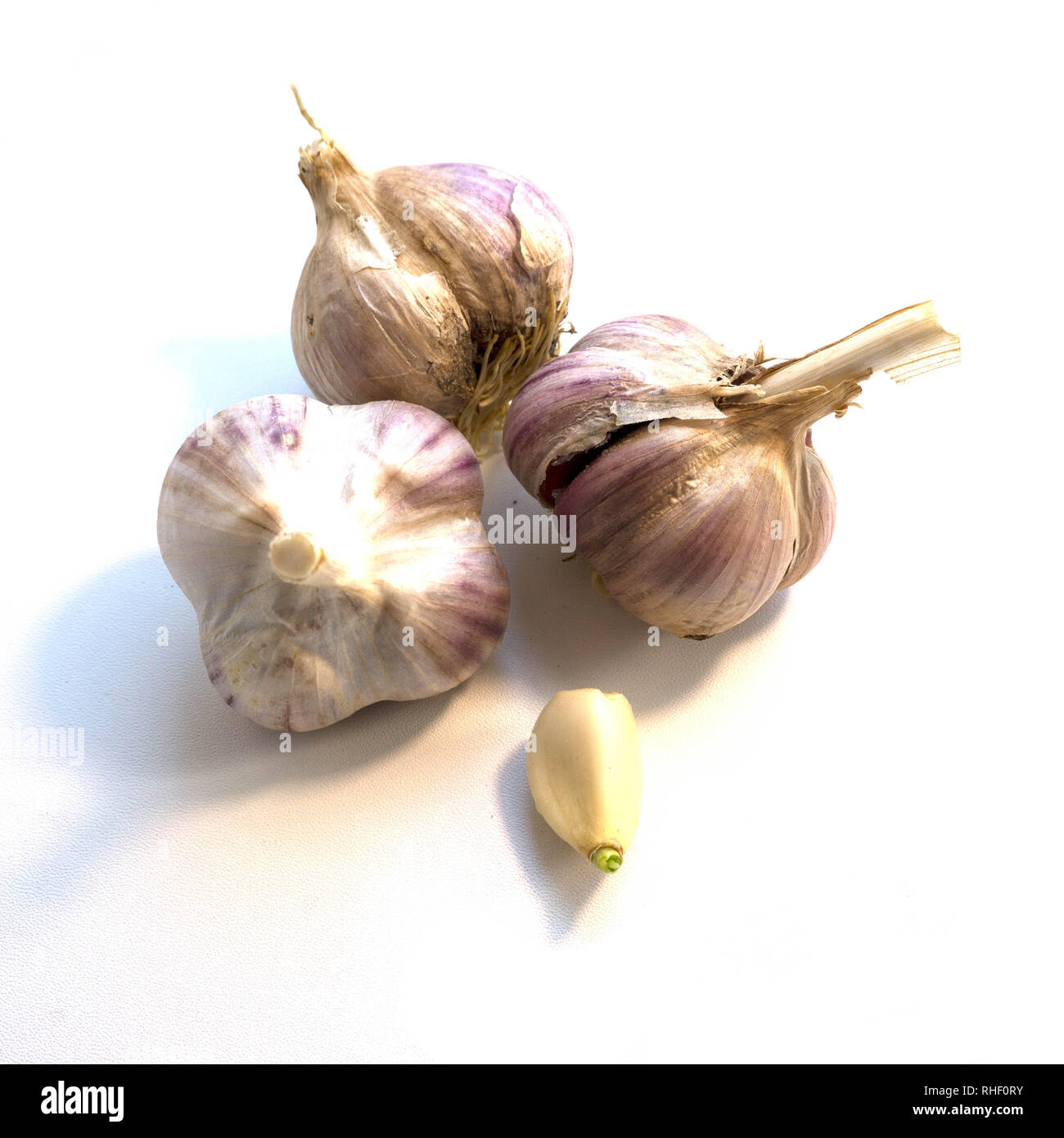 Heads of garlic and the cleaned clove on a white background Stock Photo ...
