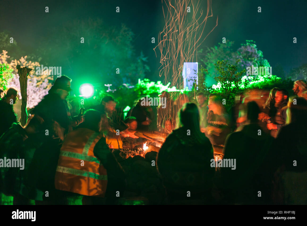 A long exposure of people sitting around a camp fire Stock Photo