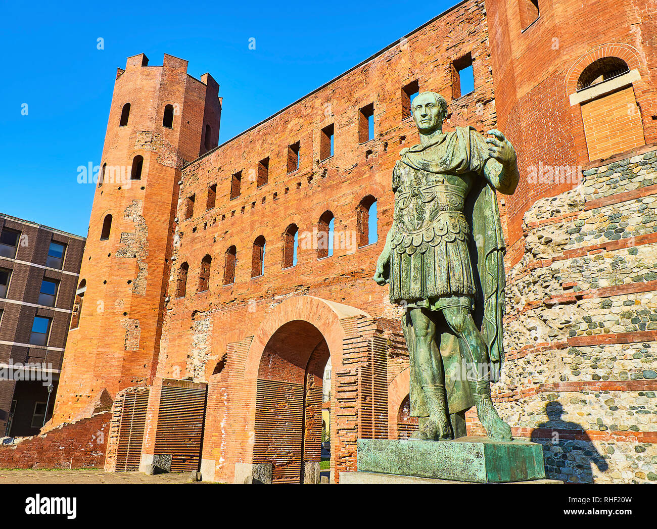 Gaius Julius Caesar Statue in front of Porta Palatina Gate. Piazza Cesare Augusto square. Turin, Piedmont, Italy. Stock Photo