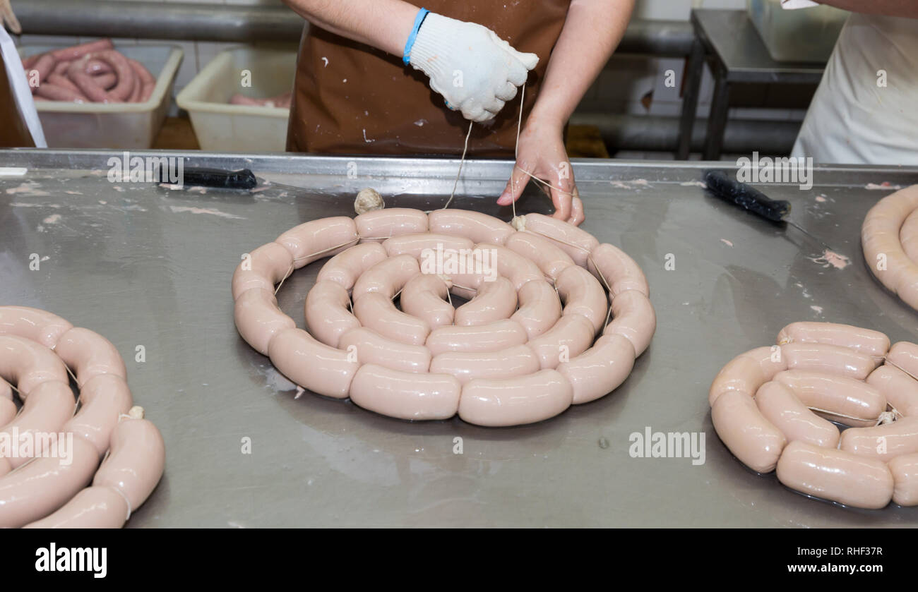 Process of manual binding of raw sausages before cooking at meat factory Stock Photo Alamy