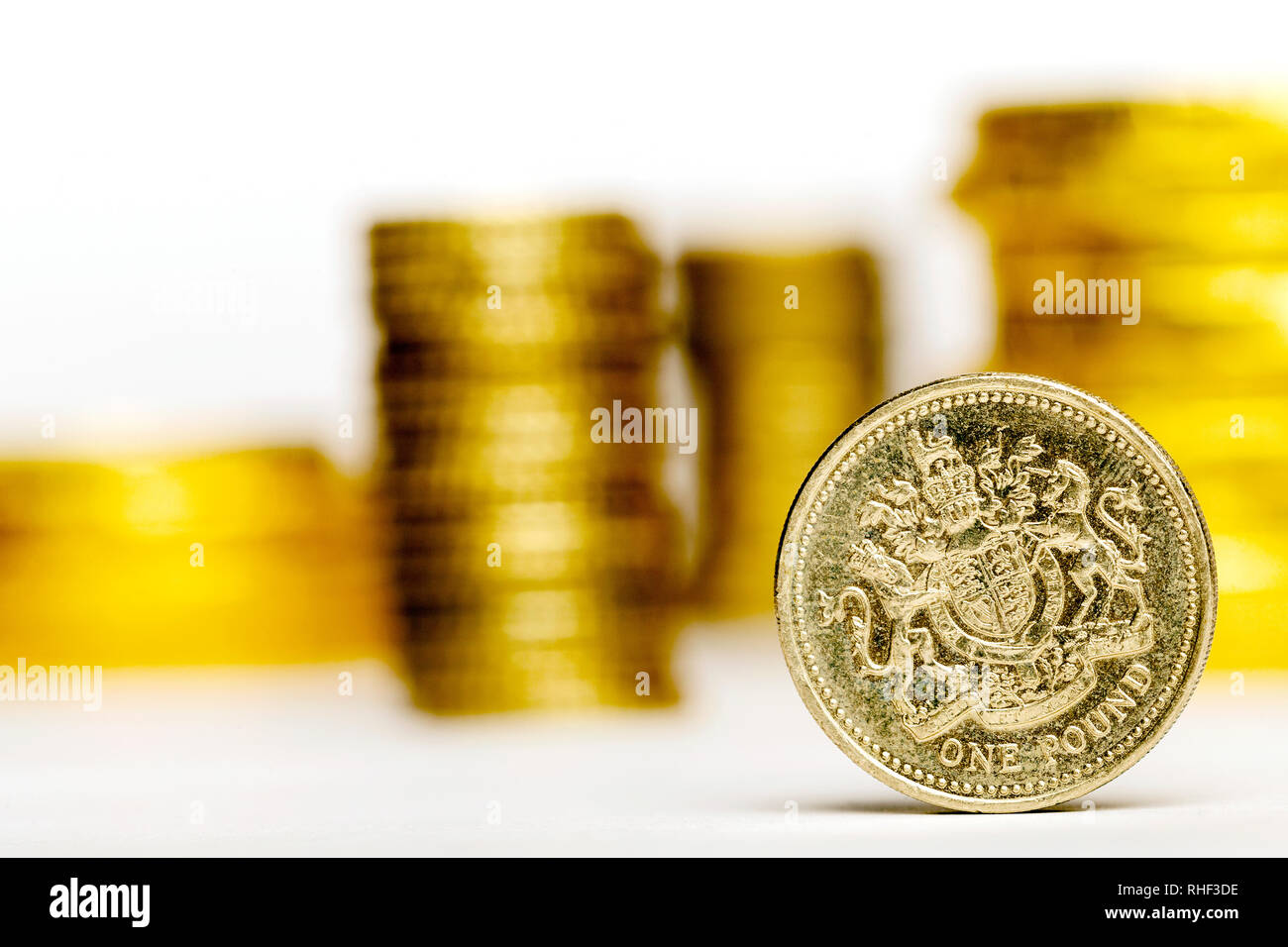 Close up of One British Pound with blurred money on the white background Stock Photo