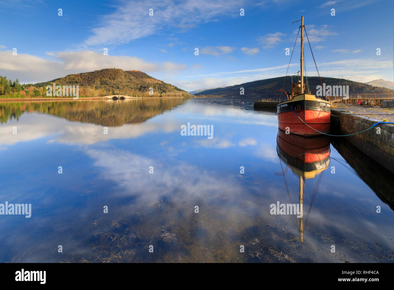 Reflections in Inveraray Harbour with Dun na Cuaiche in the distance. Stock Photo